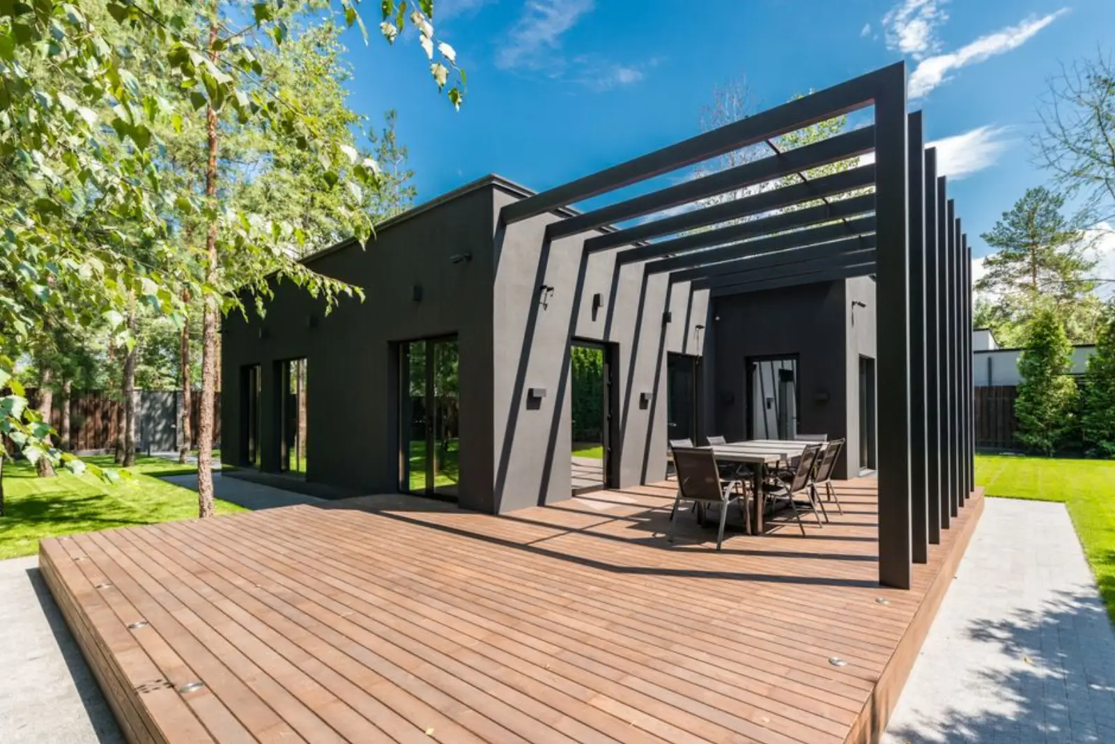 Anthracite pergola over a timber deck at a family house
